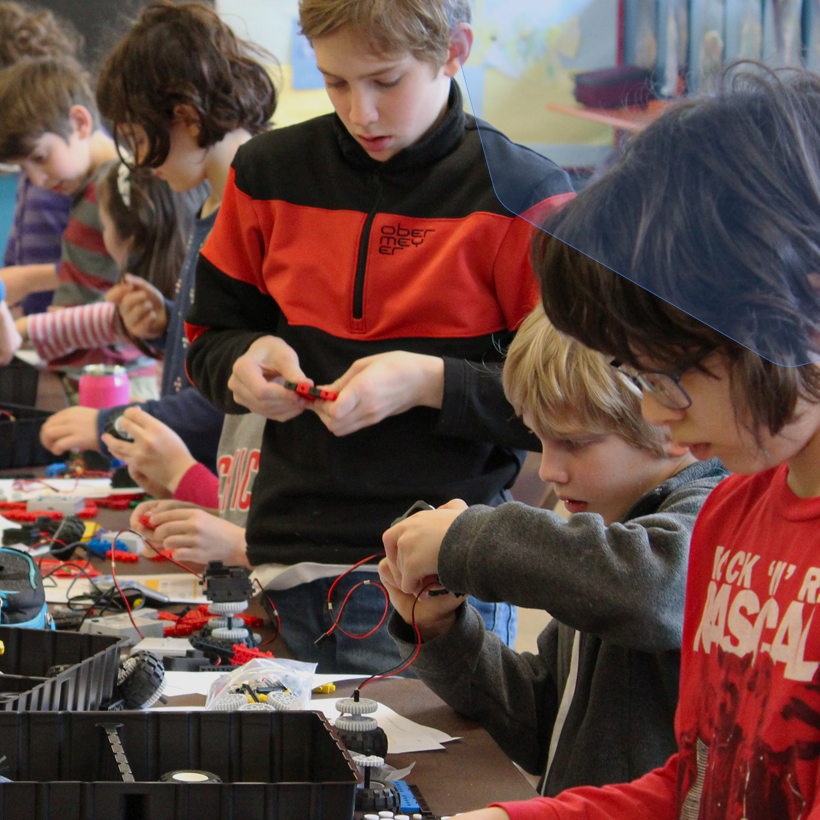 Kids building robots together in class